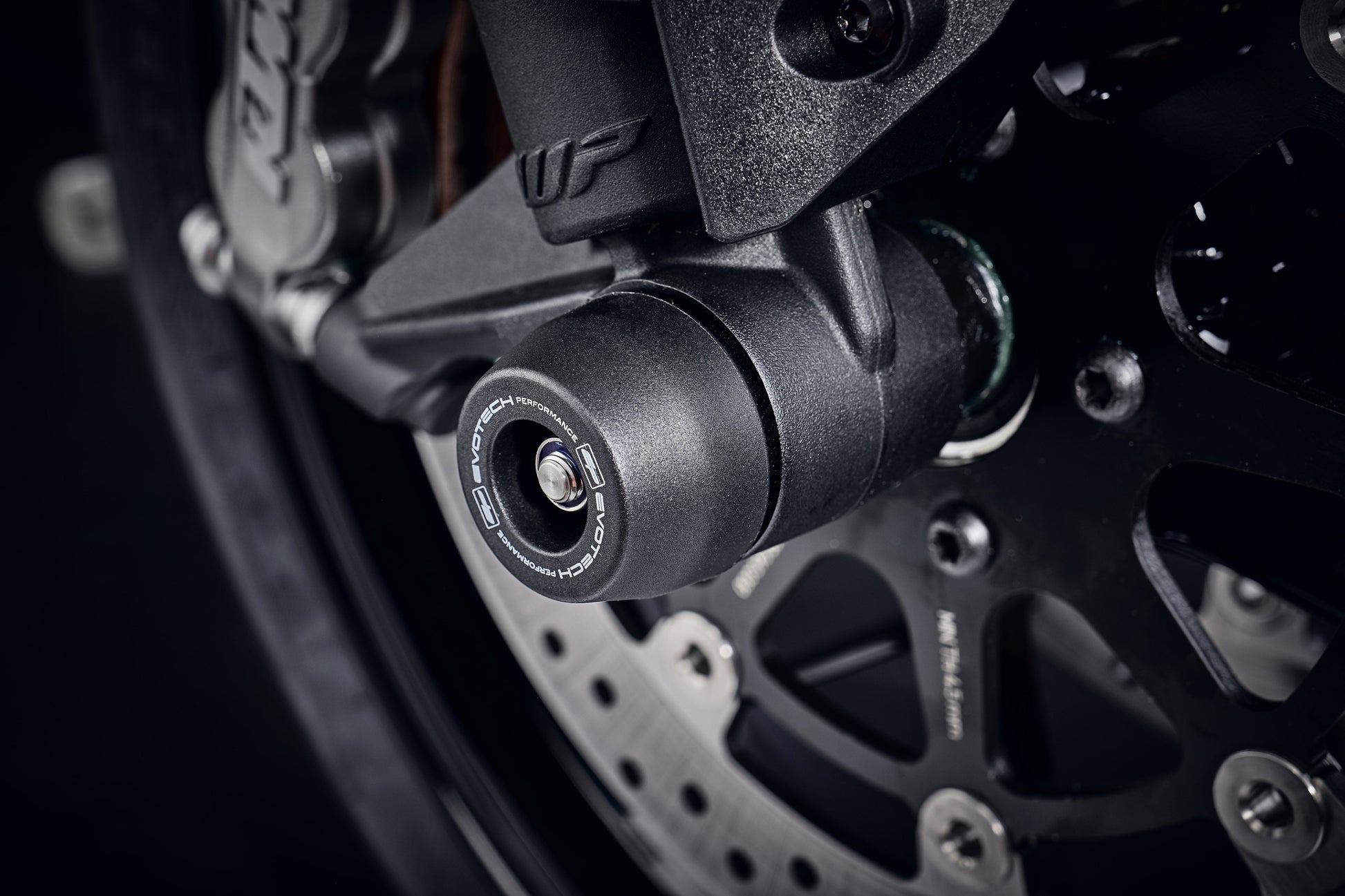 The injection-moulded nylon crash bung of EP Front Spindle Bobbins installed onto the front wheel of the KTM 790 Duke, giving strong crash protection to the front forks and brake calipers.